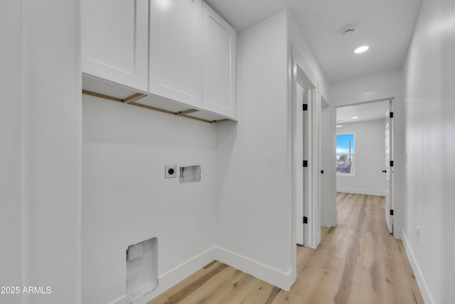 laundry area featuring hookup for a washing machine, baseboards, hookup for an electric dryer, cabinet space, and light wood-style floors