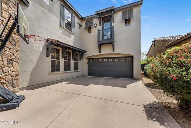 9285 E Canyon Vw, Scottsdale, AZ 85255 - rear view of house featuring a garage, driveway, a balcony, and stucco siding