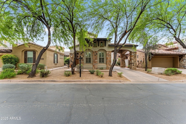 9285 E Canyon Vw, Scottsdale, AZ 85255 - mediterranean / spanish home featuring stone siding, driveway, and stucco siding