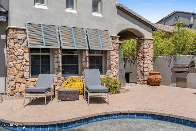 9285 E Canyon Vw, Scottsdale, AZ 85255 - back of property with exterior kitchen, stone siding, a patio, and stucco siding
