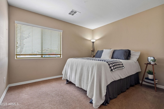 carpeted bedroom featuring visible vents and baseboards