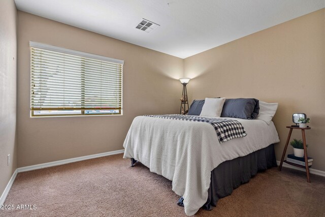 carpeted bedroom featuring visible vents and baseboards