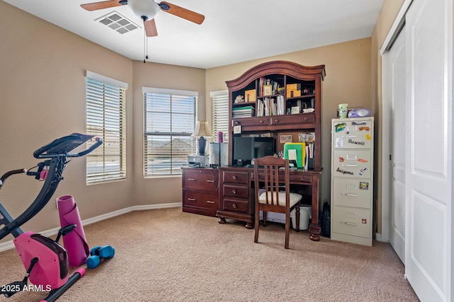 carpeted office with visible vents, baseboards, and ceiling fan