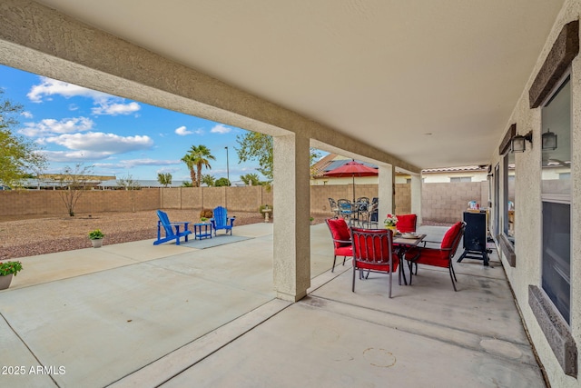 view of patio with outdoor dining area and a fenced backyard