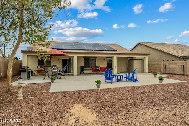 back of property with a patio area, outdoor dining area, a fenced backyard, and stucco siding