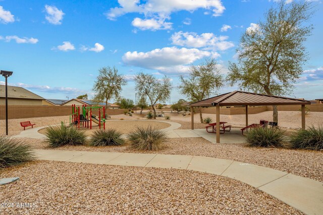 view of yard with a gazebo, fence, playground community, and a patio area