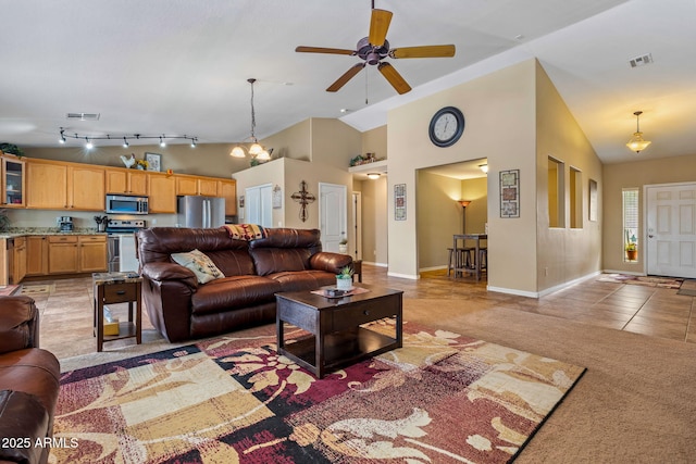 living area featuring light tile patterned floors, a ceiling fan, visible vents, high vaulted ceiling, and light colored carpet