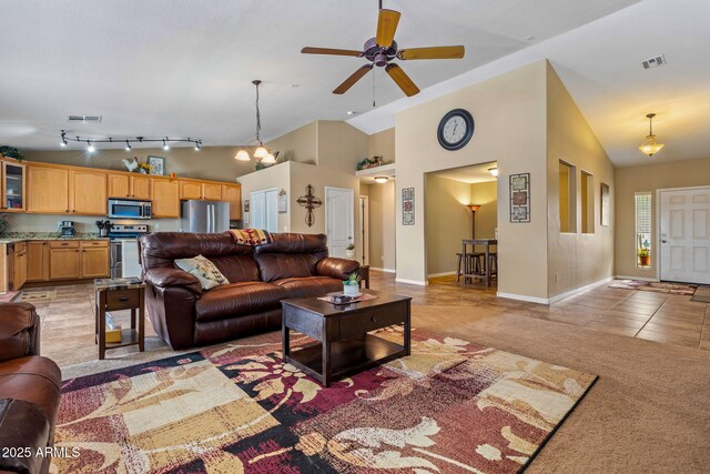 living area featuring light tile patterned floors, a ceiling fan, visible vents, high vaulted ceiling, and light colored carpet