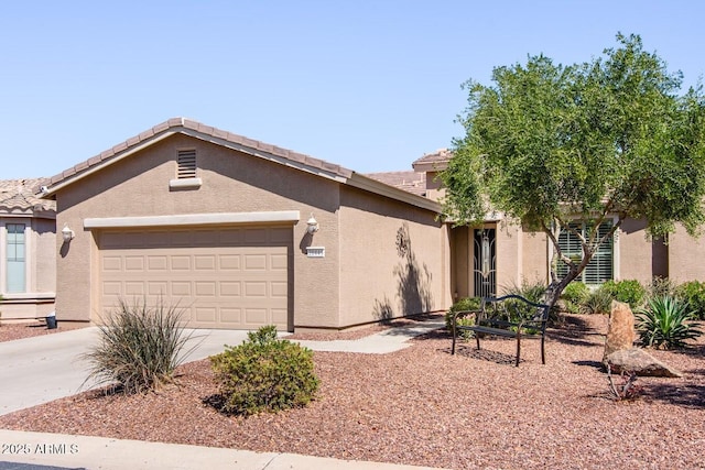 ranch-style house featuring a tiled roof, an attached garage, driveway, and stucco siding