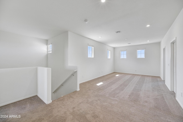 below grade area featuring baseboards, recessed lighting, visible vents, and light carpet