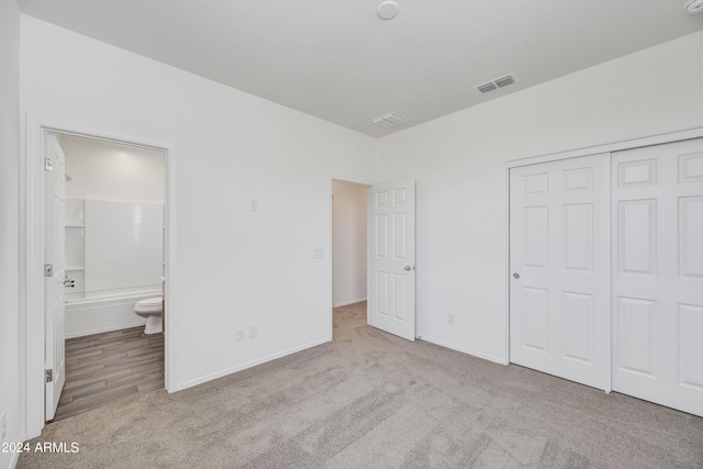 unfurnished bedroom featuring carpet, visible vents, and baseboards