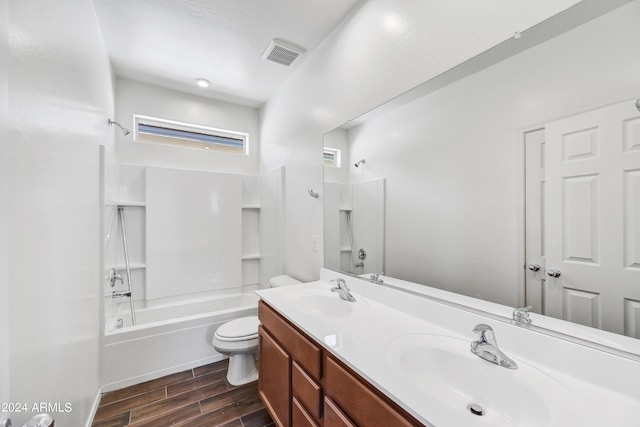 bathroom featuring visible vents, wood tiled floor, toilet, and a sink