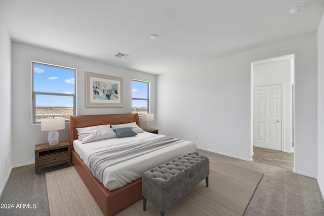 carpeted bedroom with baseboards and visible vents