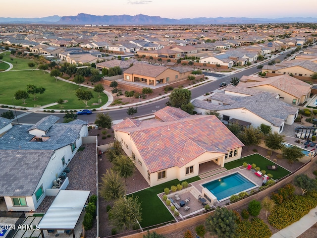 aerial view at dusk featuring a mountain view