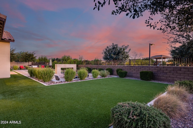 yard at dusk featuring a gazebo