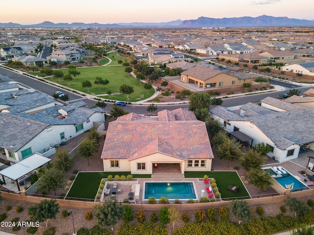 aerial view at dusk featuring a mountain view