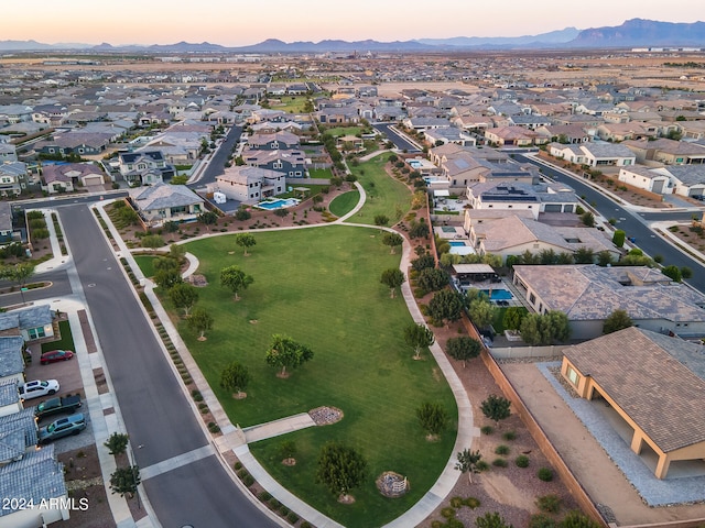 aerial view at dusk featuring a mountain view