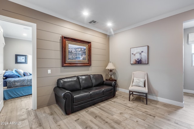 sitting room featuring light hardwood / wood-style flooring and ornamental molding