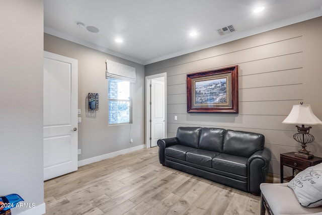 living room featuring light hardwood / wood-style floors and crown molding