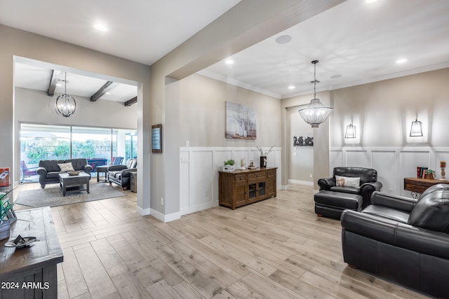 living room featuring crown molding, light hardwood / wood-style floors, beam ceiling, and an inviting chandelier