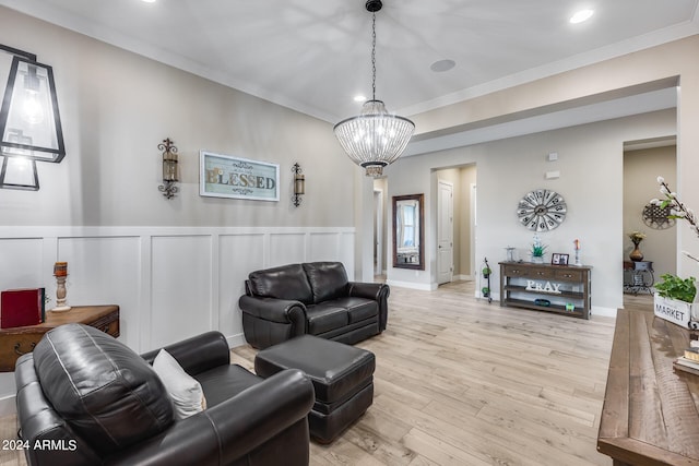 living room featuring crown molding, light hardwood / wood-style floors, and a notable chandelier