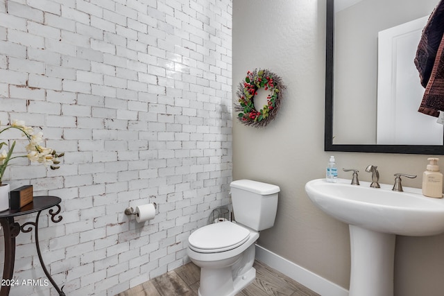 bathroom with sink, hardwood / wood-style flooring, and toilet