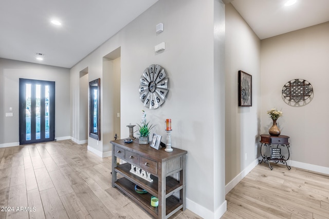 entryway featuring light wood-type flooring and french doors