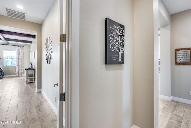 hallway with light hardwood / wood-style floors