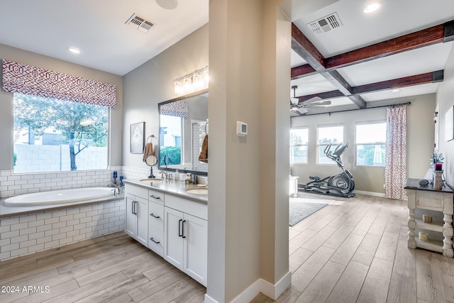 bathroom with vanity, hardwood / wood-style floors, ceiling fan, and a wealth of natural light