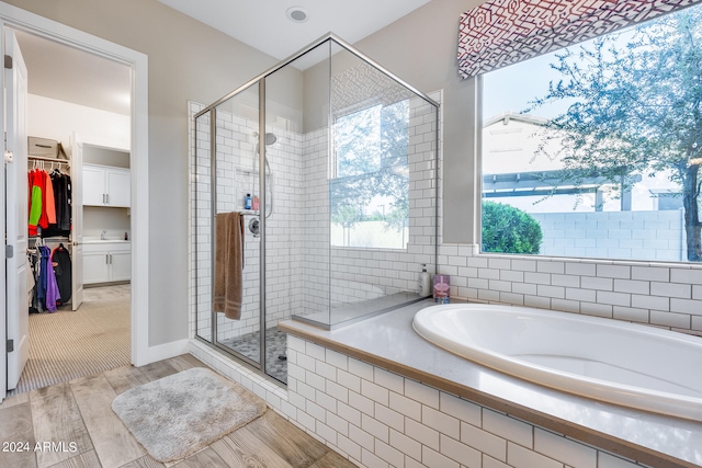 bathroom with shower with separate bathtub and hardwood / wood-style floors