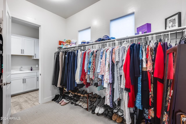 walk in closet featuring light wood-type flooring and sink