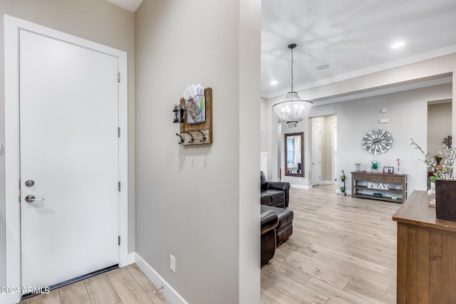 foyer with an inviting chandelier and light hardwood / wood-style flooring