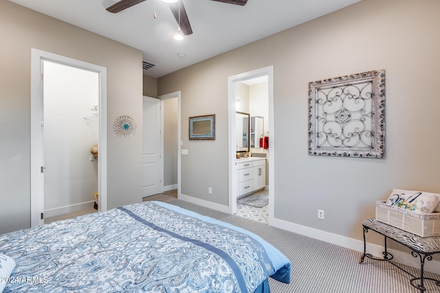 carpeted bedroom with ensuite bath and ceiling fan