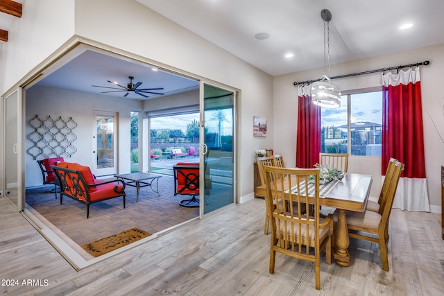 dining area featuring light wood-type flooring, ceiling fan, and plenty of natural light