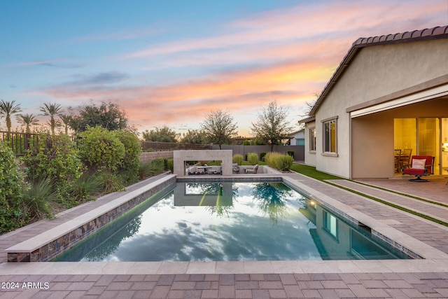 view of pool at dusk