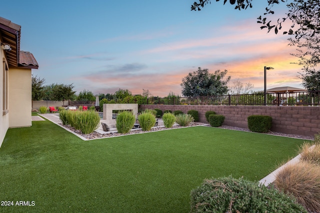 yard at dusk featuring a gazebo