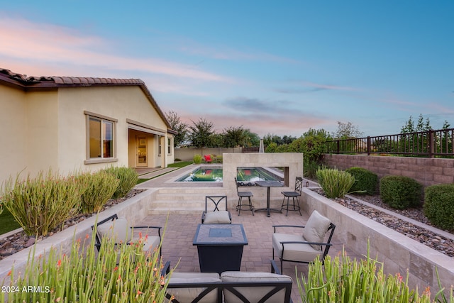 view of patio terrace at dusk