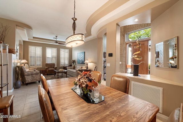 7291 E Eagle Feather Rd, Scottsdale, AZ 85266 - dining area with healthy amount of natural light, light tile patterned floors, ceiling fan, and baseboards