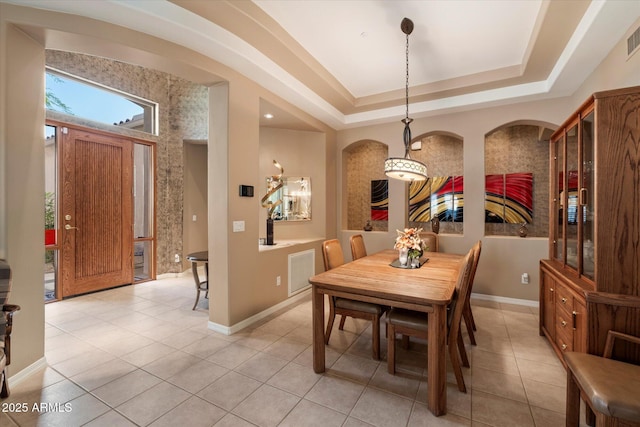 7291 E Eagle Feather Rd, Scottsdale, AZ 85266 - dining room featuring light tile patterned floors, baseboards, and a tray ceiling