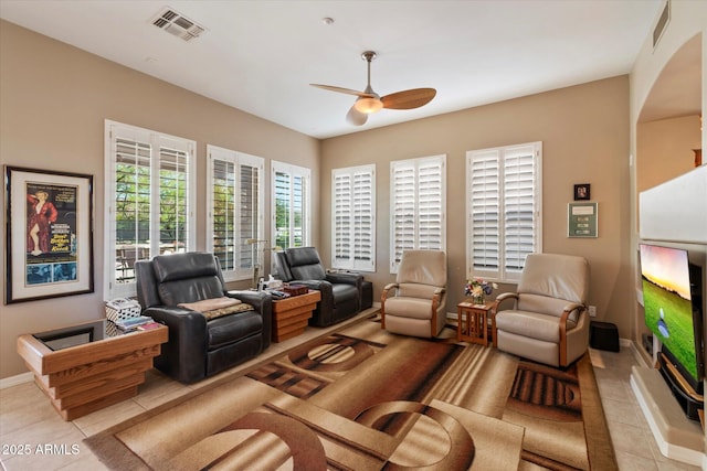 7291 E Eagle Feather Rd, Scottsdale, AZ 85266 - living room with light tile patterned floors, a ceiling fan, baseboards, and arched walkways