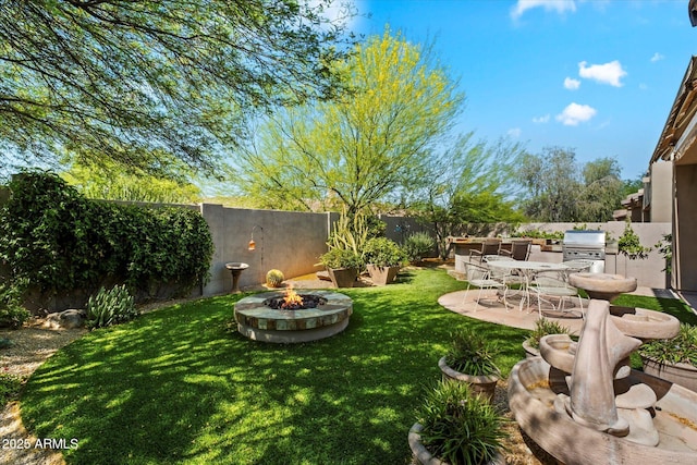 7291 E Eagle Feather Rd, Scottsdale, AZ 85266 - view of yard featuring area for grilling, an outdoor fire pit, and a patio
