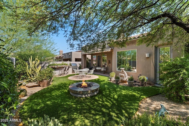 7291 E Eagle Feather Rd, Scottsdale, AZ 85266 - rear view of house with an outdoor fire pit, stucco siding, a yard, and a patio area