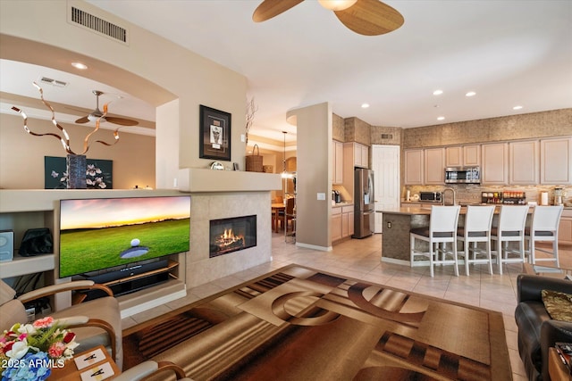 7291 E Eagle Feather Rd, Scottsdale, AZ 85266 - living room with light tile patterned flooring, a ceiling fan, baseboards, a fireplace, and recessed lighting