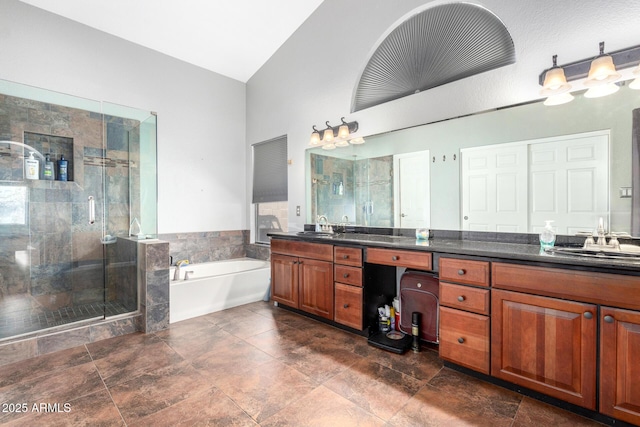 bathroom featuring a bath, vaulted ceiling, a shower stall, and vanity