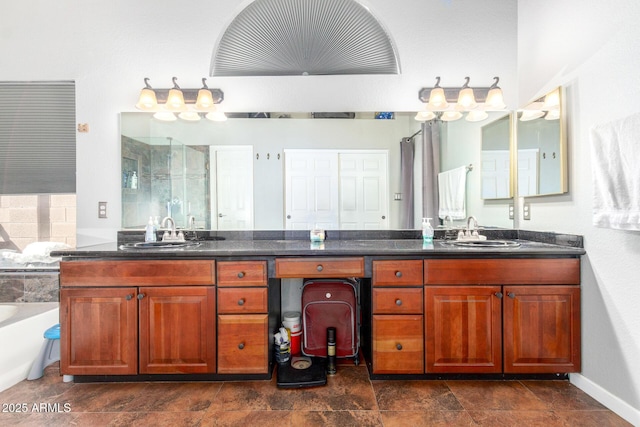 bathroom with a bathing tub, a shower stall, stone finish floor, and vanity