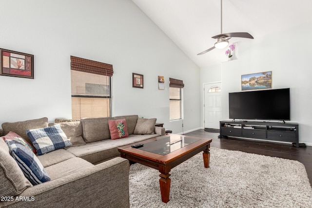 living area with a ceiling fan, high vaulted ceiling, baseboards, and wood finished floors