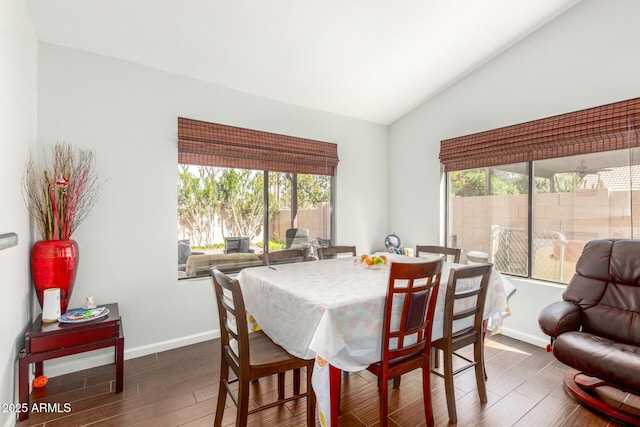 dining area with lofted ceiling, wood finished floors, and baseboards