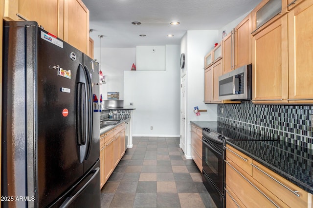 kitchen with baseboards, decorative backsplash, dark countertops, glass insert cabinets, and black appliances