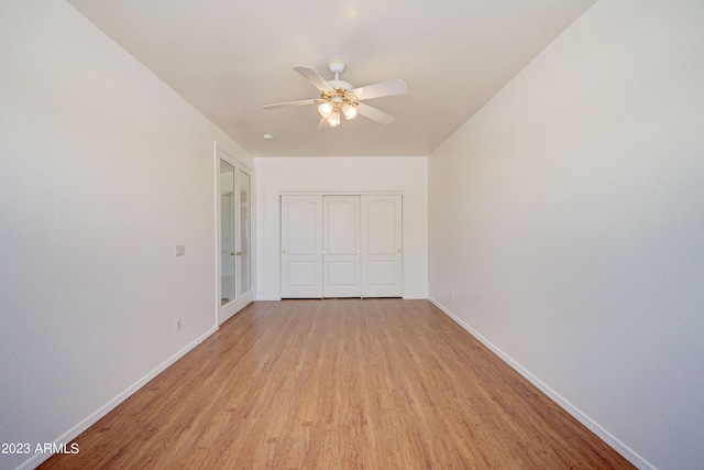 spare room with ceiling fan and light wood-type flooring