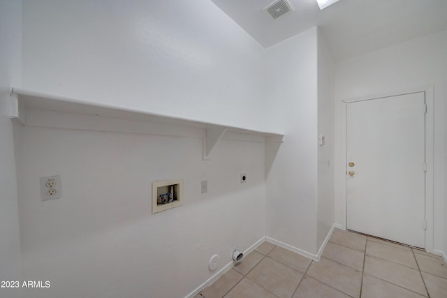 laundry room with light tile flooring, hookup for a washing machine, hookup for a gas dryer, and hookup for an electric dryer